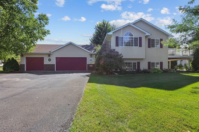 view of front of property with a garage and a front lawn