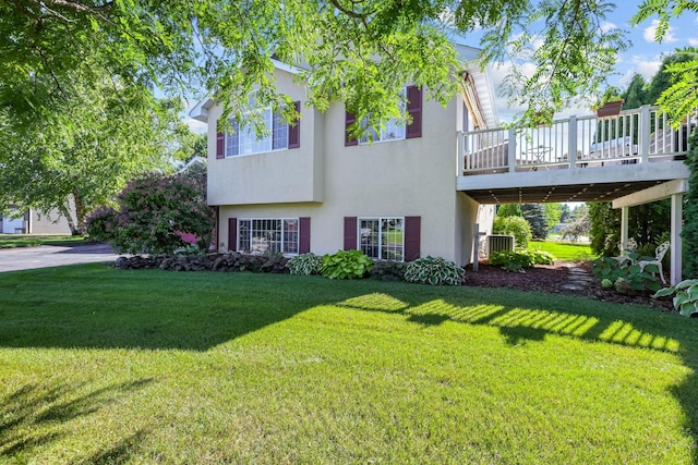 view of front facade with a wooden deck, central AC, and a front lawn