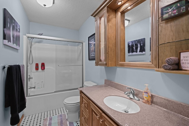 full bathroom featuring tile patterned floors, toilet, vanity, enclosed tub / shower combo, and a textured ceiling