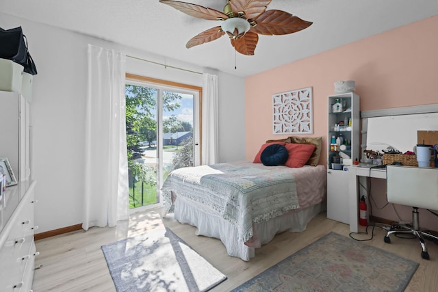 bedroom with light wood-style flooring, a ceiling fan, and baseboards