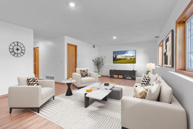 living area featuring recessed lighting, visible vents, and light wood-style floors