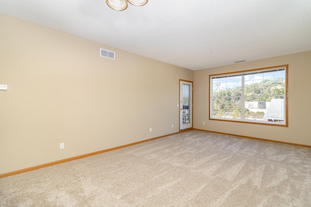 unfurnished room featuring light carpet