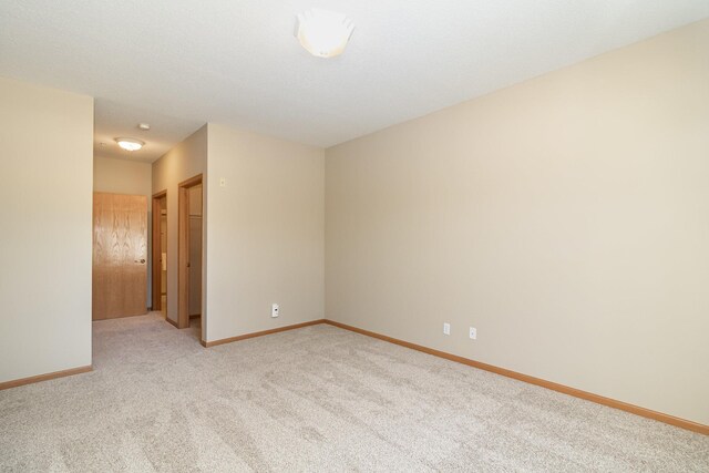 empty room with light colored carpet