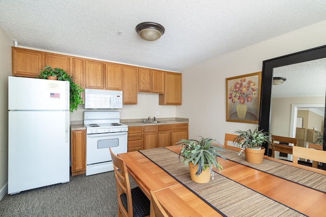 kitchen featuring white appliances, a textured ceiling, dark hardwood / wood-style floors, and sink