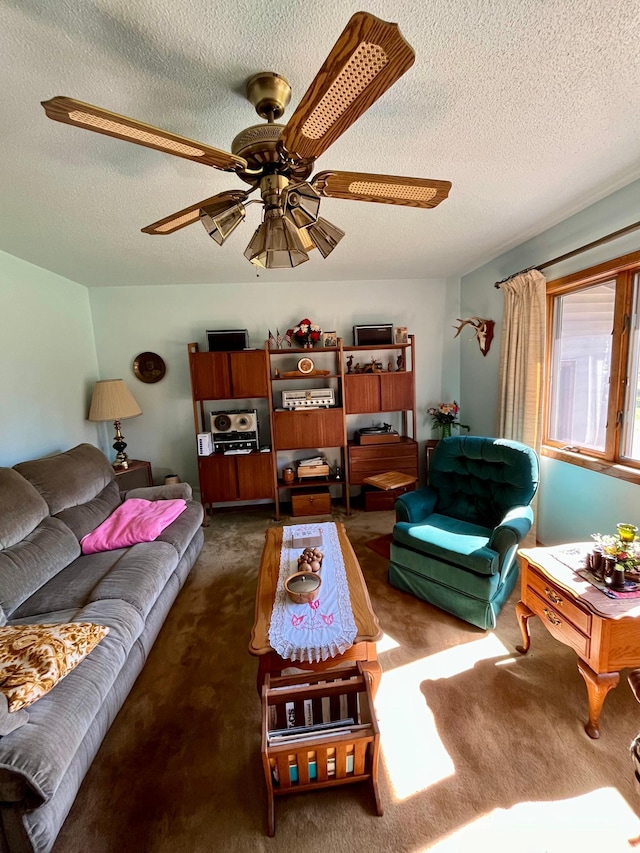 carpeted living room with a textured ceiling and ceiling fan