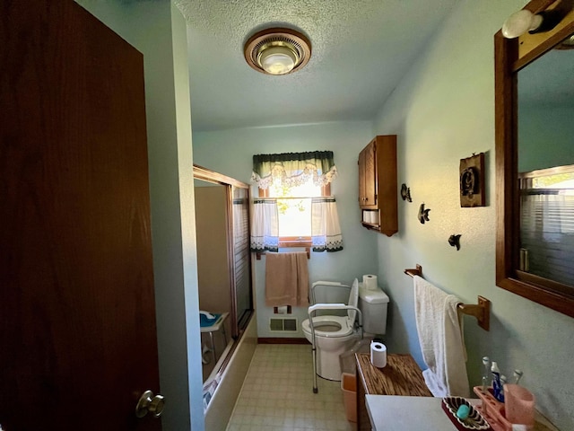 bathroom with walk in shower, a textured ceiling, vanity, and toilet