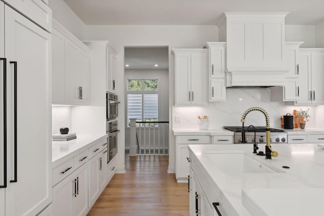 kitchen featuring white cabinets, light countertops, and paneled fridge
