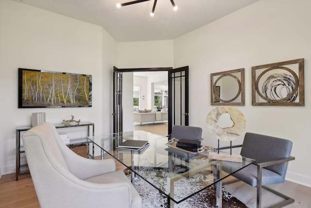 living area featuring baseboards and wood finished floors