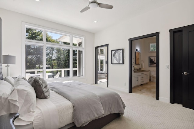 bedroom with ensuite bathroom, light carpet, baseboards, and recessed lighting