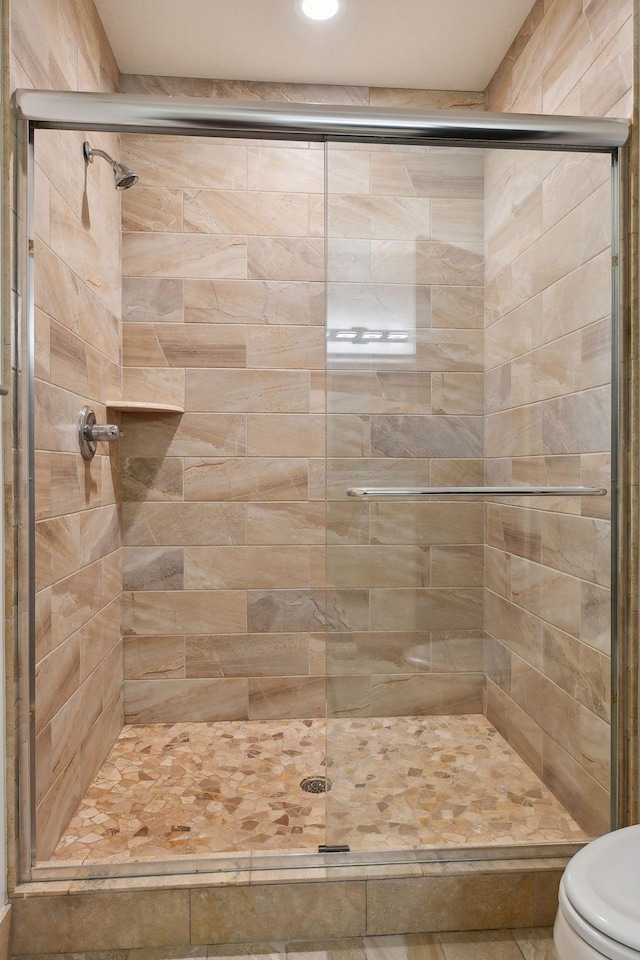 bathroom featuring a stall shower, recessed lighting, and toilet