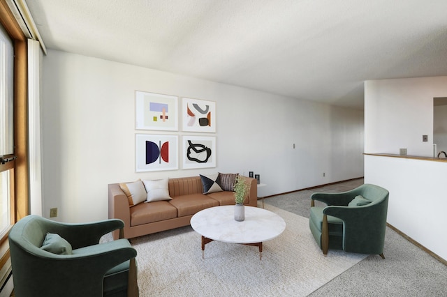 carpeted living room with a textured ceiling and a healthy amount of sunlight