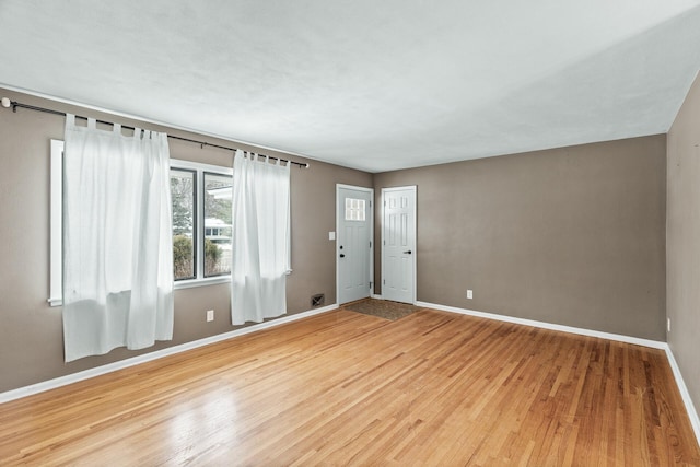 empty room with hardwood / wood-style flooring