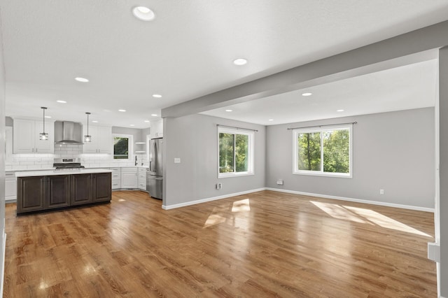 unfurnished living room featuring hardwood / wood-style flooring