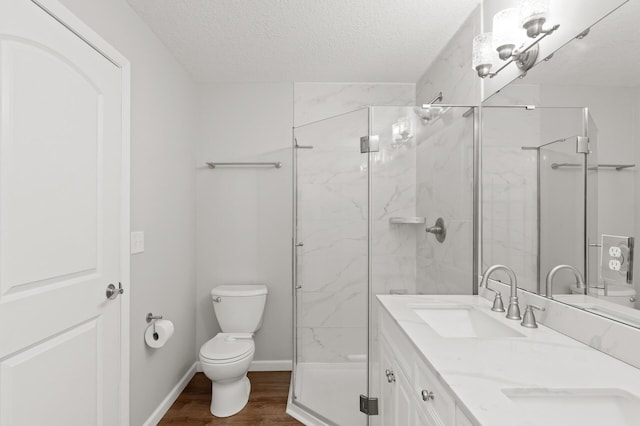 bathroom with walk in shower, hardwood / wood-style floors, a textured ceiling, and toilet