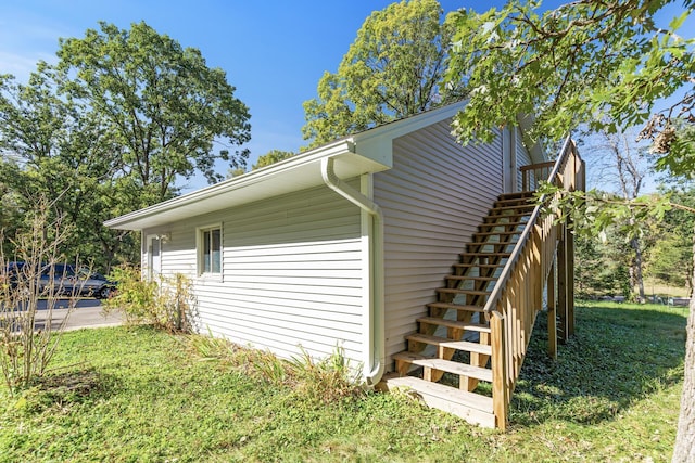 view of side of home featuring a lawn