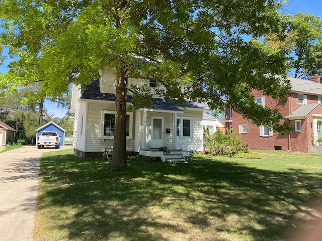 view of front of property with a garage, crawl space, an outdoor structure, a front lawn, and driveway