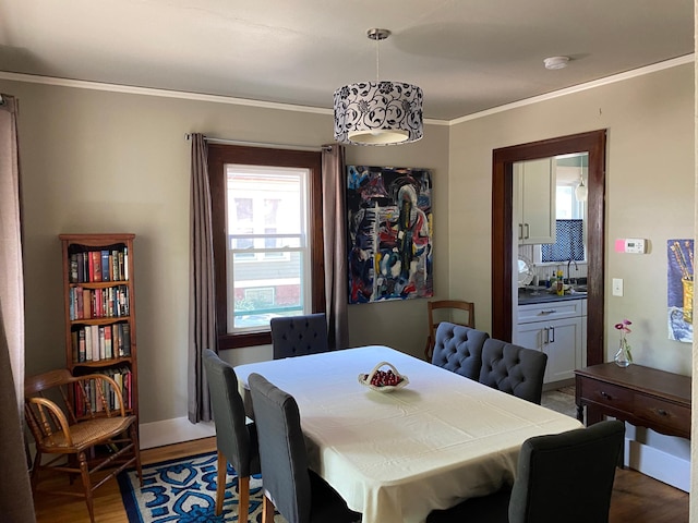 dining space featuring crown molding and dark hardwood / wood-style flooring