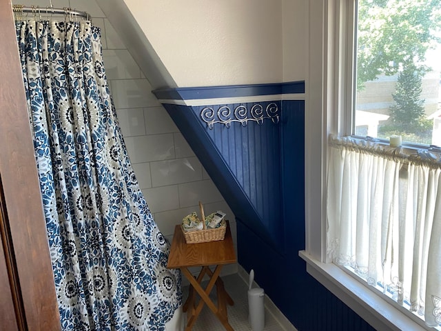 bathroom featuring tile patterned floors and a healthy amount of sunlight