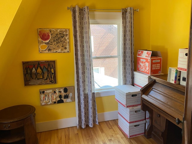 interior space featuring wood finished floors and baseboards
