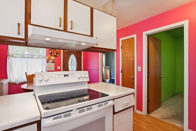 kitchen featuring white cabinetry, electric range, and light hardwood / wood-style floors