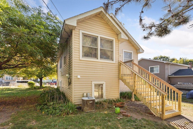 rear view of house with central AC unit