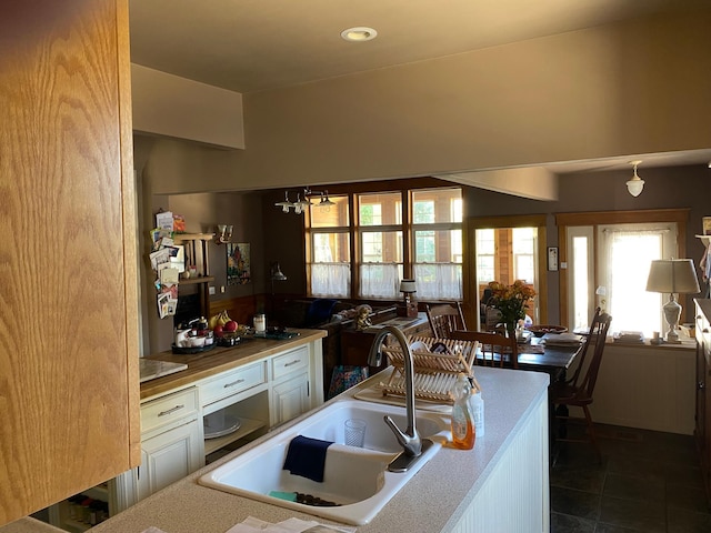 kitchen with sink and dark tile patterned floors