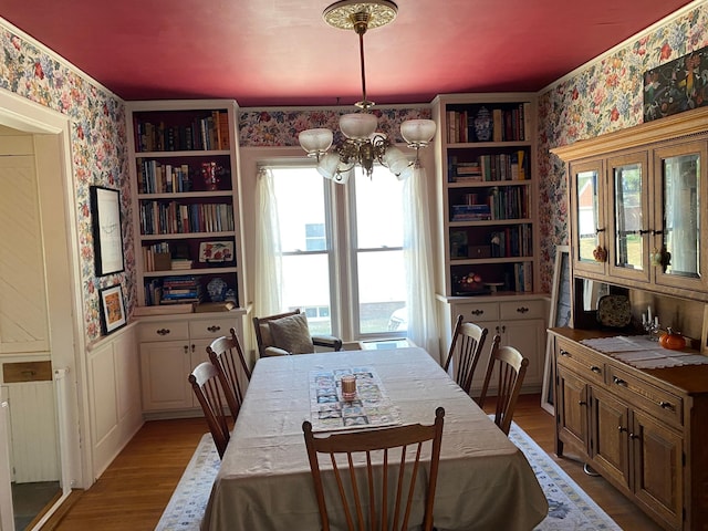 dining space featuring an inviting chandelier and light hardwood / wood-style flooring