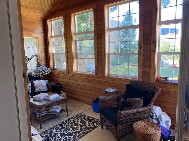 sitting room featuring wooden walls, wood ceiling, vaulted ceiling, and carpet