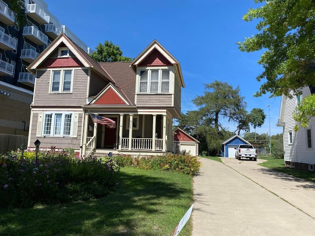 view of front facade with cooling unit, a garage, a front yard, an outdoor structure, and covered porch