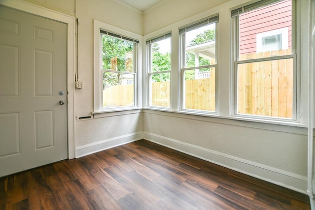 interior space featuring crown molding and dark wood-type flooring