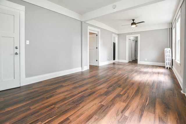 spare room with radiator, ceiling fan, and dark hardwood / wood-style flooring