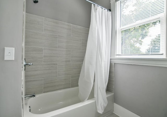 bathroom featuring shower / tub combo with curtain