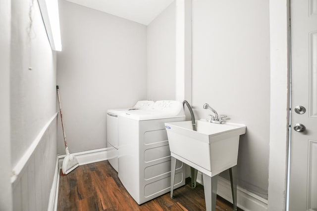 clothes washing area featuring dark wood-type flooring and washer and dryer