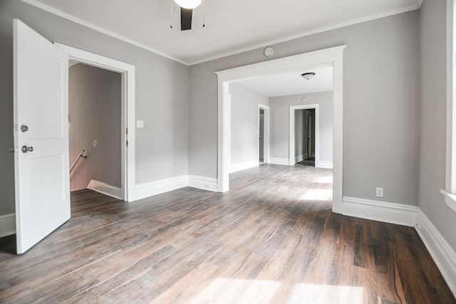 spare room featuring ceiling fan, dark hardwood / wood-style floors, and crown molding