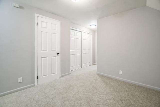 spare room featuring light colored carpet