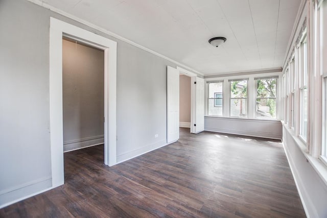 unfurnished room featuring dark hardwood / wood-style floors and ornamental molding