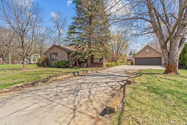 8011 Long Lake Rd, Mounds View, MN 55112 - view of front of home with brick siding, a garage, a front yard, and an outdoor structure