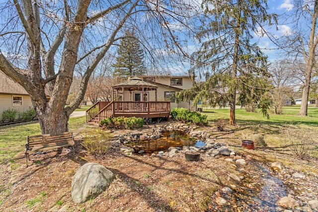 8011 Long Lake Rd, Mounds View, MN 55112 - back of house featuring a wooden deck and a lawn
