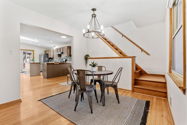 8011 Long Lake Rd, Mounds View, MN 55112 - dining room with a chandelier, light wood finished floors, stairway, and recessed lighting