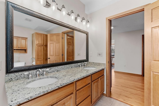 8011 Long Lake Rd, Mounds View, MN 55112 - full bathroom with double vanity, tile patterned flooring, and vaulted ceiling