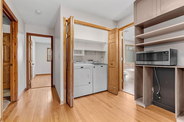 8011 Long Lake Rd, Mounds View, MN 55112 - washroom featuring washing machine and dryer and light wood-type flooring
