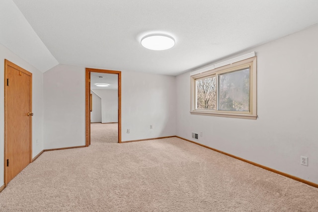 8011 Long Lake Rd, Mounds View, MN 55112 - carpeted empty room featuring baseboards and vaulted ceiling