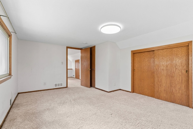 8011 Long Lake Rd, Mounds View, MN 55112 - unfurnished bedroom featuring carpet flooring, a closet, and lofted ceiling