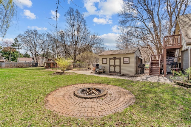 8011 Long Lake Rd, Mounds View, MN 55112 - view of yard with an outbuilding, stairway, an outdoor fire pit, a wooden deck, and a patio