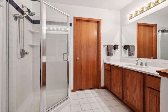 bathroom with vanity, tile patterned flooring, and a shower with door