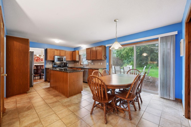 dining space with light tile patterned floors and sink