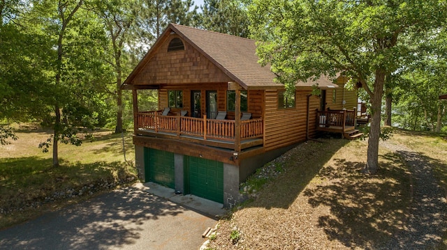 log-style house with a deck and a garage