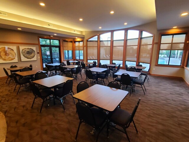 carpeted dining room with plenty of natural light and french doors