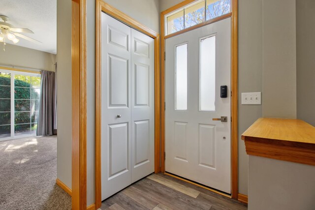 foyer entrance featuring light hardwood / wood-style floors and ceiling fan