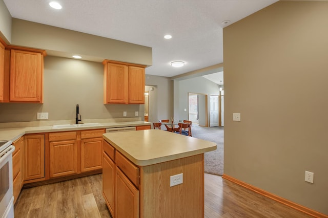 kitchen with sink, light wood-type flooring, white electric stove, and a kitchen island